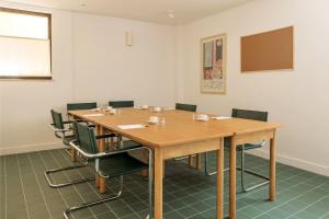 a conference room with a wooden table and chairs at Alfred Hotels Monaco - Hôtel avec rooftop in Beausoleil
