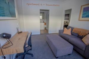 a living room with a couch and a table at Banyan Place in Warrnambool