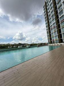 a large swimming pool in the middle of a building at Mahkota Valley Suite, Lemmie Stay in Kuantan