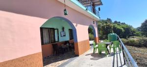 ビムタルにあるAasara Homestay Bhimtalの外にテーブルと椅子がある建物