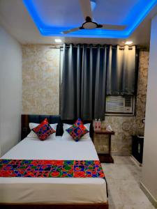 a bedroom with a bed with a blue ceiling at Hotel Shiv Grand SV in Kānpur