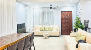 a living room with a couch and a tv at Matthews Home Cebu-Casa Uno in Cebu City