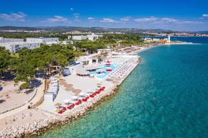 an aerial view of a beach with umbrellas and the ocean at Resort Šibenik in Šibenik +56 photos