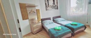 a small bedroom with two beds and a dresser at Bike Hostel&Camp in Przewóz +24 photos