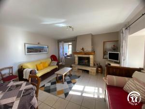 a living room with a couch and a fireplace at Gîte de caractère à Verlac in Verlac