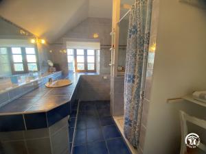 a large bathroom with a sink and a shower at Gîte de caractère à Verlac in Verlac +23 photos