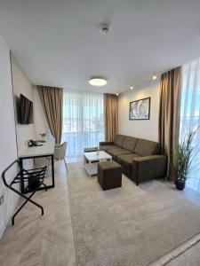 a living room with a couch and a table at Hotel Cat Deluxe in Sanski most