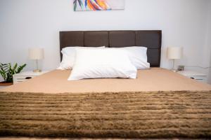 a bed with a white pillow on top of it at Lion's Nest in Mesochórion