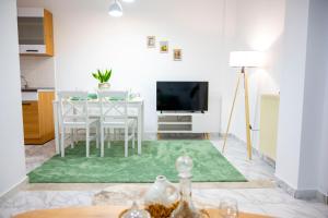 a living room with a table and a television at Lion's Nest in Mesochórion