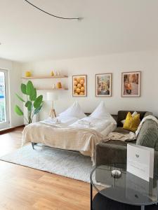 a living room with a bed and a couch at Apartmenthaus Gilden 7 in Borken