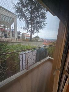 a balcony with a view of a tree at GiannisHouse in Florina