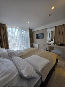 a large bedroom with four beds with white pillows at Hotel Cat Deluxe in Sanski most +28 photos