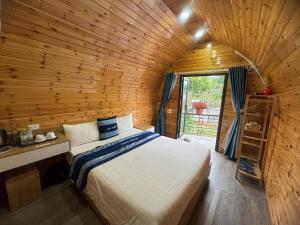 a bedroom with a bed in a wooden room at Plum Homestay Đồng Văn in Dồng Văn +91 photos