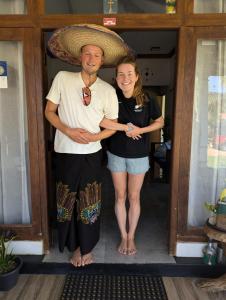 a man and a woman standing in a doorway at Aiden Homestay in Pasikuda