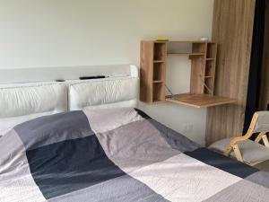 a bedroom with a bed and a chair and a shelf at Studio neuf - entrée indépendante - sans cuisine in Nantes