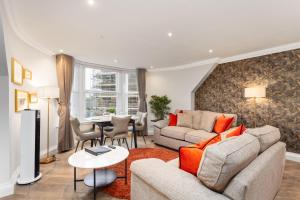 a living room with a couch and a table at Central Edinburgh Prime Luxury in Edinburgh