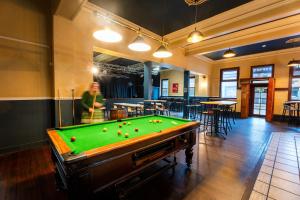 a man in a room with a pool table at The Burlington Hotel in Bunbury