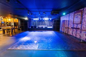 an empty dance floor in a room with a stage at The Burlington Hotel in Bunbury
