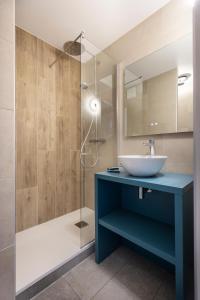 a bathroom with a blue sink and a shower at Hôtel Club mmv Les Bergers **** in L'Alpe-d'Huez