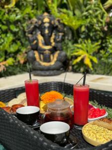 a tray of food with red candles on a table at Villa Licia - Seseh area in Balian