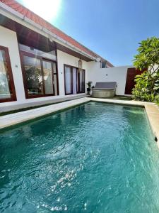a swimming pool in front of a house at Villa Licia - Seseh area in Balian