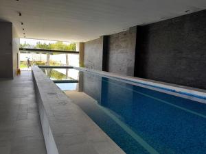 a large swimming pool in a building at Luxury Penthouse with Jacuzzi & Views in Puebla
