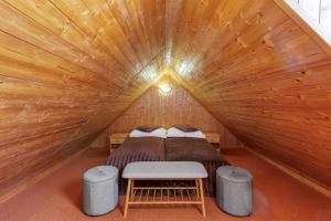 a bedroom with a bed in a wooden room at Hotel BELLA in Prague