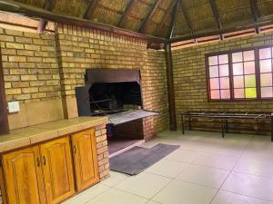 a brick kitchen with an oven in a brick wall at The N1 Farm Place in Pretoria