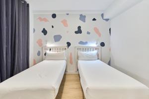 two beds in a room with hearts on the wall at Hostal Carmen by gaiarooms in Salamanca