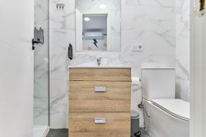 a bathroom with a sink and a toilet and a mirror at Hostal Carmen by gaiarooms in Salamanca