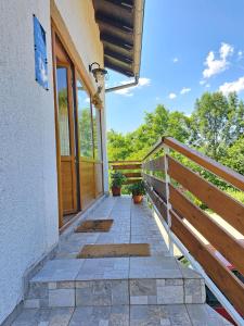 a porch of a house with a wooden door at Guesthouse Zafran in Smoljanac