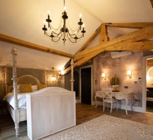 a bedroom with a large bed and a table at Old School House, Halkyn in Halkyn