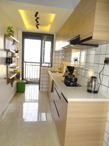 a kitchen with a sink and a stove at Cozy Top-Floor Apartment with Balcony & City Views near United Nations Office in Ruaka +14 photos