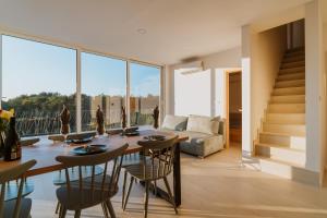 a living room with a table and chairs and a couch at Marmor Collis by Winery Glavica in Gornja Gračenica