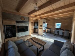 a living room with a couch and a table at Domek Widokowy Tyniok in Koniaków