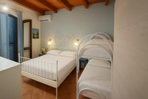Postel nebo postele na pokoji v ubytování Il giardino di Malu'