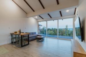 a living room with a table and a couch at Marmor Collis by Winery Glavica in Gornja Gračenica