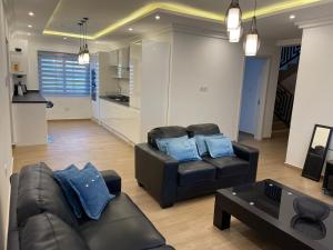 a living room with two couches and a table at Jupiter Villa 1 and 2 in Afienya