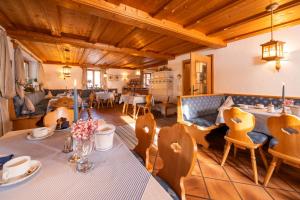 a living room with a table and chairs at Hotel garni Reiffenstuel in Rottach-Egern