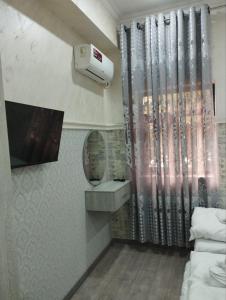 a bathroom with a sink and a hair dryer at Minor Hotel in Toshkent-Passajir Bekati
