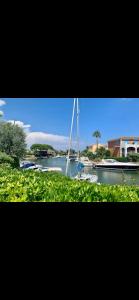 a sailboat on a river with a boat in the water at T2 port Cogolin golfe de Saint-Tropez vue mer in Cogolin