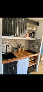 a kitchen with a sink and wooden counter top at T2 port Cogolin golfe de Saint-Tropez vue mer in Cogolin