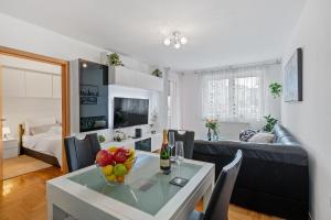 a living room with a table with fruit on it at D&T Apartment Arena Zagreb in Zagreb