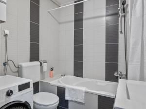 a bathroom with a tub and a toilet and a sink at D&T Apartment Arena Zagreb in Zagreb +11 photos