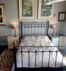 a bedroom with a bed and two lamps on tables at Cottage on Roux in Smithfield