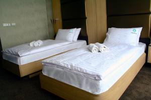A bed or beds in a room at Portobello Wellness & Yacht Hotel Esztergom