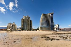 a beach with three tall buildings in the background at 1102 Ocean View in Strand