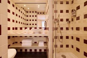a bathroom with a shower and a sink at Hotel Maison Monceau in Paris