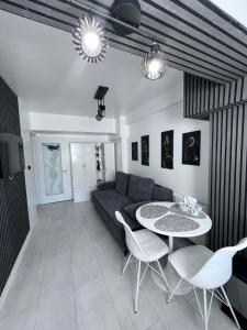a living room with a couch and a table and chairs at Apartament Nedianu in Craiova