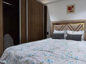 a bedroom with a large bed with a wooden headboard at Le Casablanca in Maarif